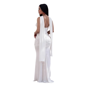 Detailed view of white sequined evening dress with flowing chiffon shoulder ribbons