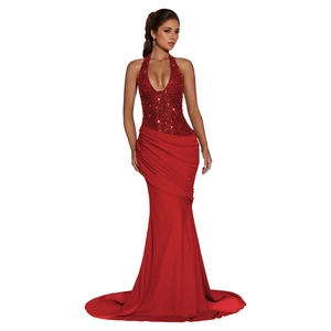 Detail of red sequined halter neck evening dress with ruched waist and fishtail hem