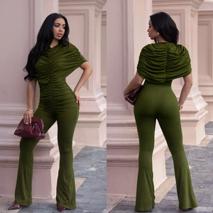 Detail showing the ruched bodice and flared leg of this elegant dark green knit jumpsuit