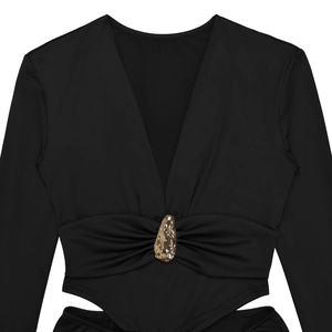 Detail of waist cut-out on a black V-neck bodysuit with a gold rhinestone buckle accessory