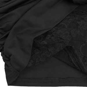 Detail of black sexy dress showing delicate floral lace patchwork and jersey texture