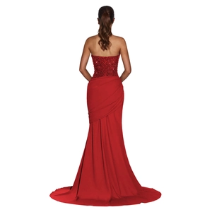 Detailed back view of elegant red sequin evening gown with adjustable lace-up open back