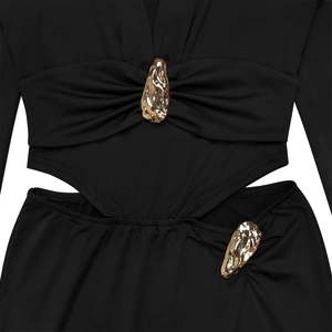 Close-up of black V-neck dress with waist cut-outs and rhinestone gold metal accents