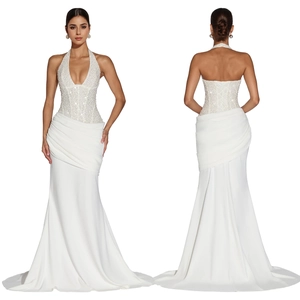 Detailed view of a white halter neck evening gown with sequins and mermaid hem