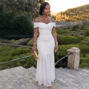 Detail of white off-shoulder ruched evening dress with elegant mesh fishtail silhouette