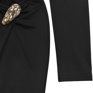 Detail of elegant black dress showing ruched fabric texture and gold hammered metal buckle