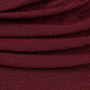 Macro shot of elegant wine red glitter knit fabric with shiny metallic sequins and texture