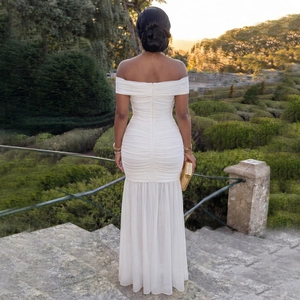 Detail of elegant white mesh dress featuring pleated texture and invisible back zipper