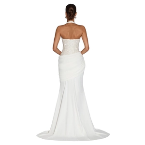 Detailed back view of white backless mermaid gown with criss-cross corset lacing and sequins