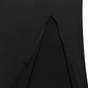 Detailed macro view of the slit hemline and refined stitching on a black mini dress