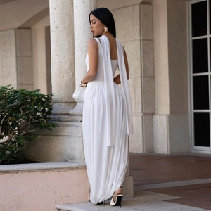 Detail of white high-waist jumpsuit featuring long shoulder ribbons and pleated harem pants