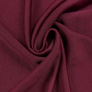 Close-up of elegant burgundy knit fabric with subtle red glitter texture and soft drapes
