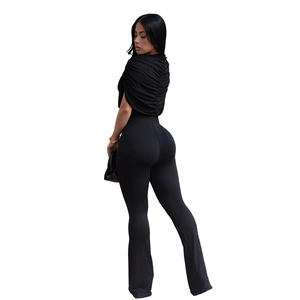 Detailed back view of sleek black backless jumpsuit with gathered folds and flared leg