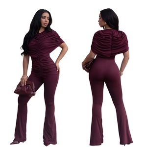 Front and back detail of elegant wine red jumpsuit with pleated cape bodice and flare leg