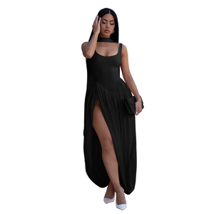Detail of elegant black sleeveless halter neck maxi dress with high slit and white pumps