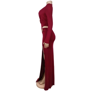 Detail of wine red two-piece set featuring waist metal ring and high side slit skirt