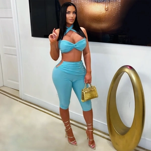 Light blue two-piece set with crisscross halter top and cutout high waist pants