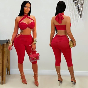 Detail of red two-piece set featuring halter criss-cross top and cutout leggings