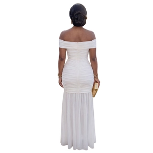 Detail of ruched white mesh fabric on a backless off-the-shoulder fishtail maxi dress