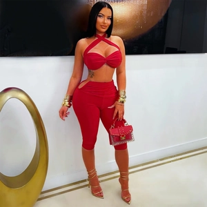 Detail of red halter knot top and cutout high-waist shorts on fashion model