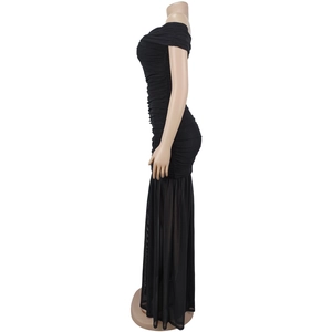 Detail of ruched black bodycon dress featuring sheer mesh mermaid hem and slim fit