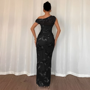 Detail of elegant black bodycon dress featuring 3D floral embroidery and one-shoulder cut