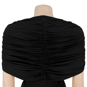 Close-up of black pleated fabric and hidden back zipper on an elegant slim jumpsuit