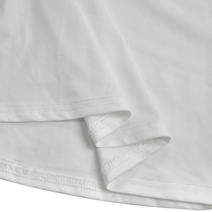 Detail of white knit fabric texture showing professional double-needle stitching and hem