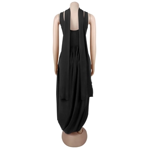 Back detail of a black maxi dress featuring long flowing ribbons and pleated waistline