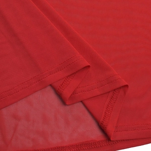 Detail shot of breathable red mesh fabric with durable double-stitched hem on the dress