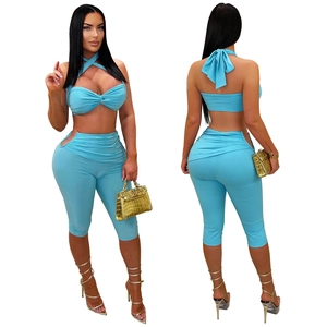 Detail of light blue two-piece set featuring cutout lace-up top and ruched slim-fit leggings