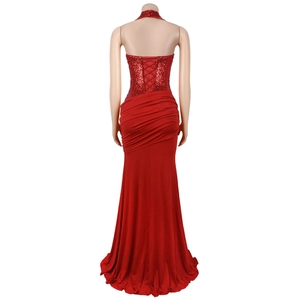 Detail of red backless halter gown featuring sequin bodice and cross-lace design