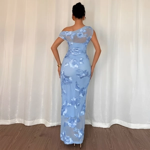 Detail of light blue mesh evening dress featuring 3D floral embroidery and one-shoulder back