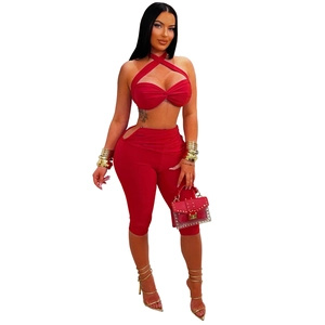 Detail of red halter crop top with twist front and high waist cutout leggings set