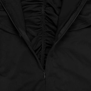 Close-up of invisible zipper and pleated details on a black slim-fit wide-leg jumpsuit