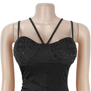 Detail of heavy beadwork and rhinestones on the neckline of a black elegant cocktail dress