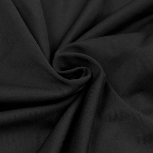 Detailed macro view of black knit fabric texture showing fine weave and soft flexibility