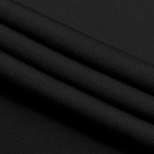 Macro detail of high-quality black ribbed knit fabric with smooth elastic texture