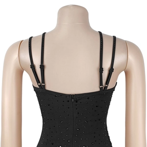 Detail of elegant black dress featuring rhinestone embellishments and adjustable straps