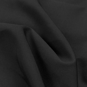 Close-up of high-quality black textile fabric with fine texture and natural matte finish