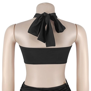 Detailed back view of black halter top featuring a large signature bow tie design
