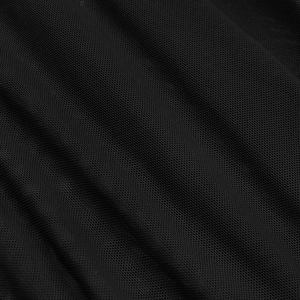 Close-up of black breathable mesh fabric texture and delicate pleats on a party dress