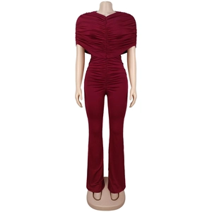 Detail view of wine red ruched jumpsuit featuring off-shoulder neckline and flared legs