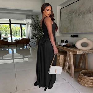 Detail of the elegant black sleeveless maxi dress showing its draped hem and waist cut