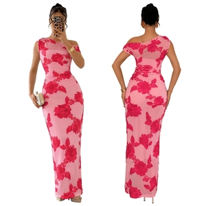 Detail of pink mesh dress with red floral print and elegant one shoulder design