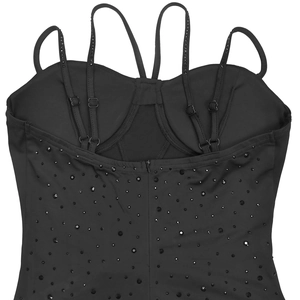 Detailed view of black rhinestones and crisscross straps on the back of this dress