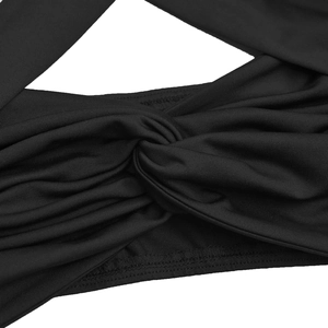 Detailed close-up of a black knit dress showing the twisted knot design and fabric texture