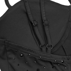 Detail of adjustable straps and decorative rhinestones on black elegant dress