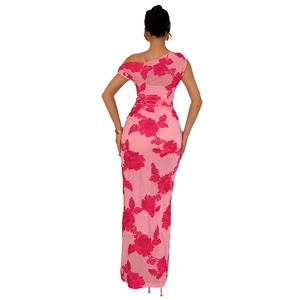 Detail of pink slim-fit dress featuring 3D red floral embroidery and mesh fabric