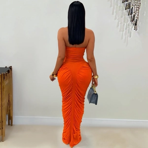 Detail view of the elegant ruched back design on this orange strapless bodycon maxi dress